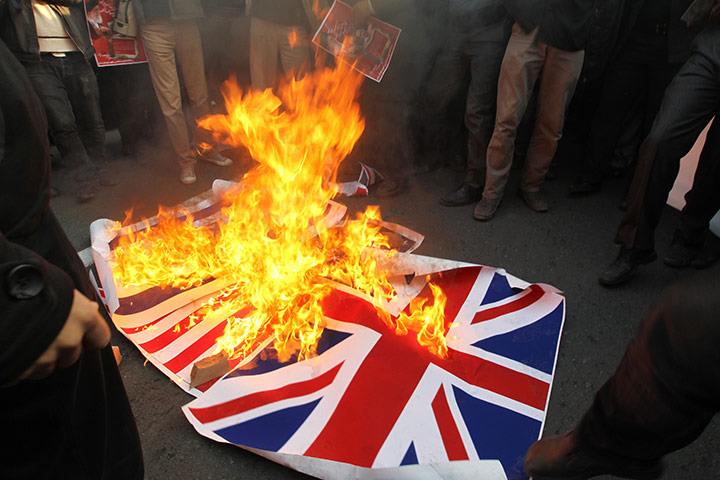 Tehran embassy: Iranian protesters burn the British flag outside the embassy in Tehran