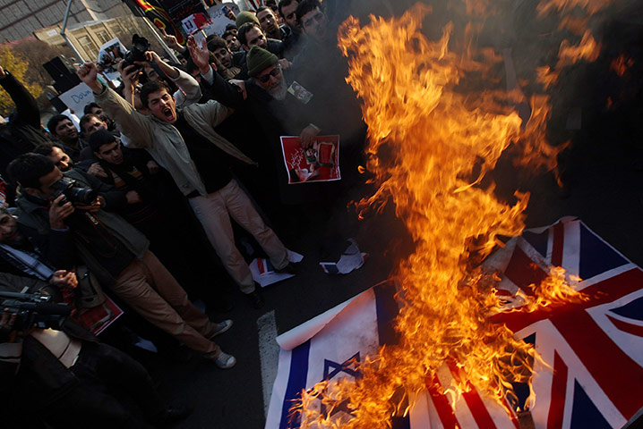 Tehran British embassy: Protesters set fire to the British and Israeli national flags