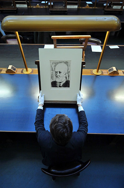 Picasso at British Museum: An employee with a print entitled 'Portrait of Vollard II' 