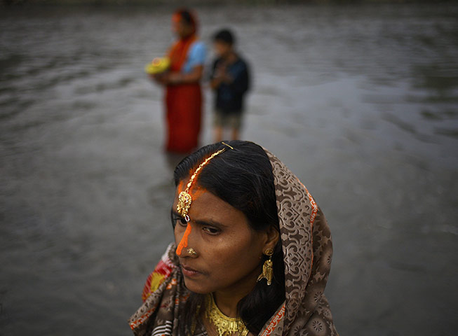 FTA: Navesh Chitrakar : A devotee prays to the setting sun during the Chhat festival in Kathmandu
