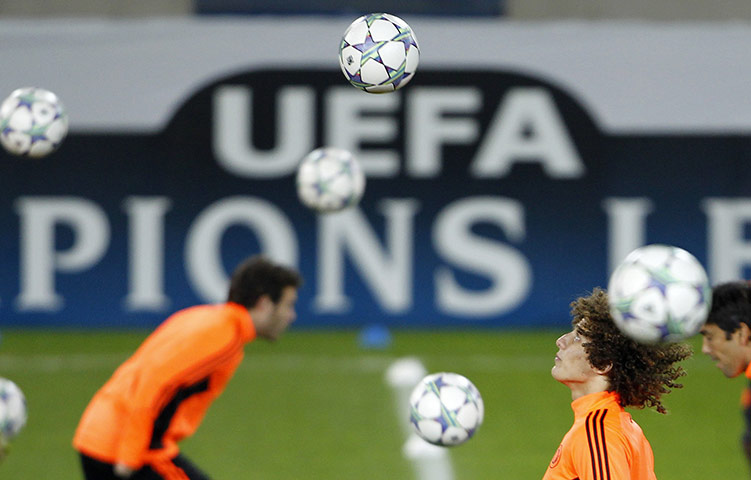 Best of the week in sport: Chelsea's Luiz heads the ball during a training session in Genk