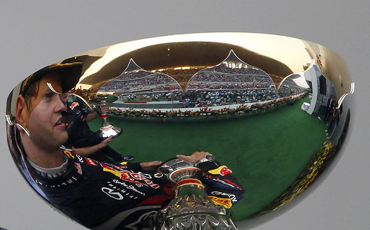 Best of the week in sport: Sebastian Vettel holds his trophy after winning the Indian Grand Prix
