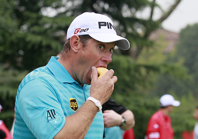 Best of the week in sport: Lee Westwood eats on the fairway at the HSBC Shanghai Champions tournament