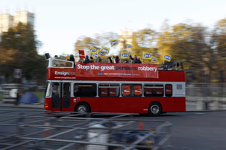 Strike day: A bus carrying union members drives through Parliament Square in London