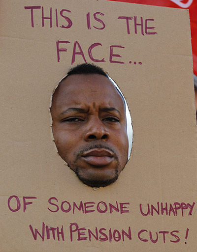 Strike day: A man wears a banner as he stands outside St Thomas's Hospital in London