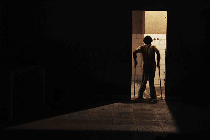 24 hours in pictures: A youth suffering from polio  in Kinshasa