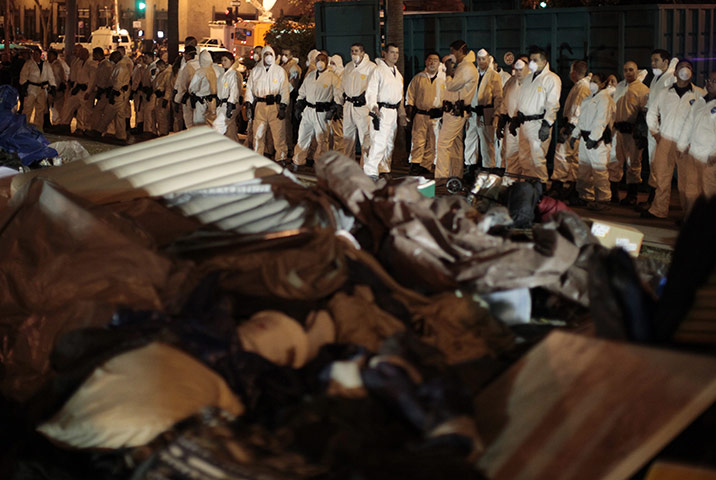 Occupy LA evictions: Los Angeles police officers in hazmat suits look over the debris