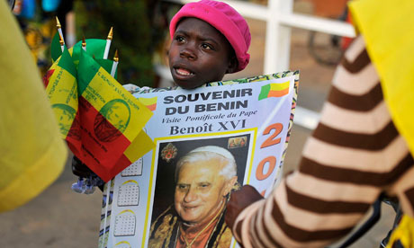 A child sells Pope Benedict souvenir posters