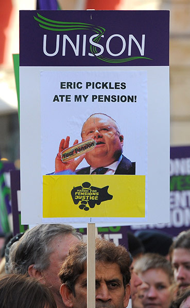 Strikers' placards: A demonstrator marches with a trade union placard featuring Eric Pickles 
