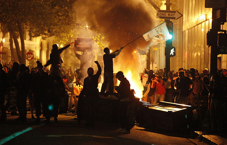 24 hours in pictures: Oakland, US: A demonstrator waves a flag