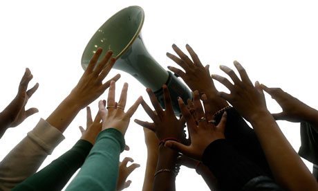 hands reaching for a megaphone