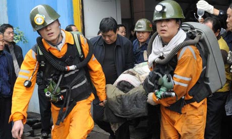 A Chinese coalminer is carried out of the Qianqium mine in Sanmenxia city, Henan province
