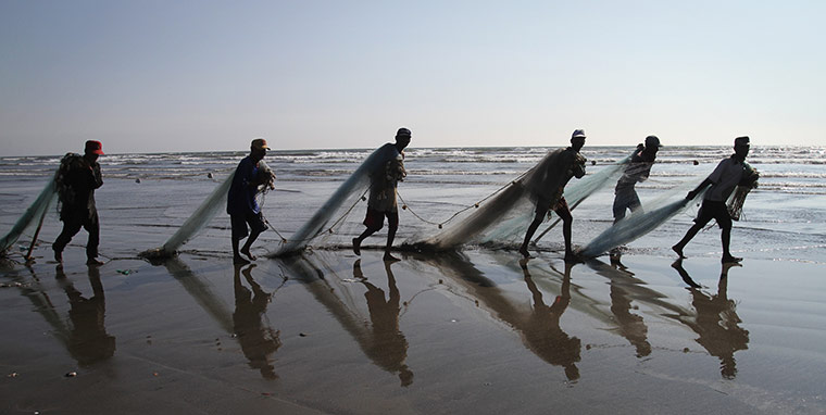 24 hours: Pakistani fishermen prepare their nets at the coast of the Arabian sea