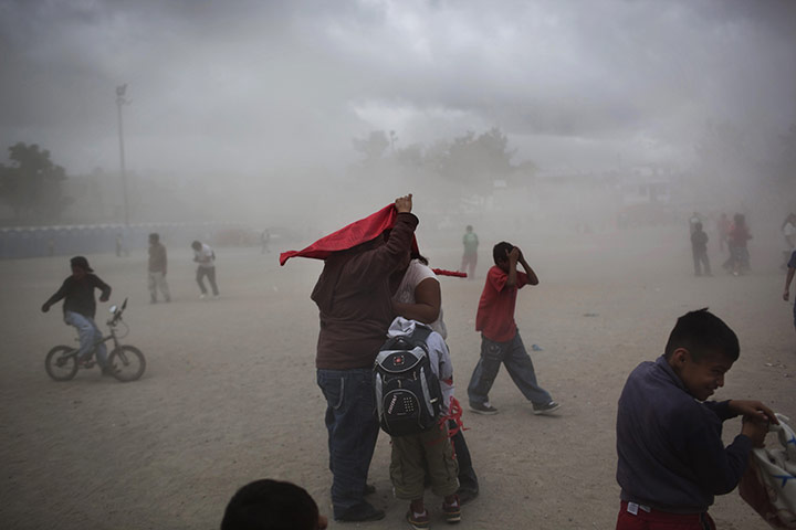 24 hours: Supporters of presidential candidate Manuel Baldizon take cover from dust