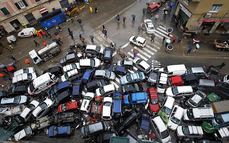 24 hours: Overturned vehicles are seen after a storm in downtown Genoa