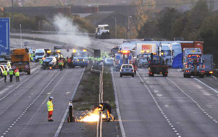 M5 crash day 2: A welder works on a central barrier on the M5 near the crash
