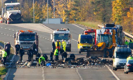 Police search through the debris on the M5 motorway in Somerset.
