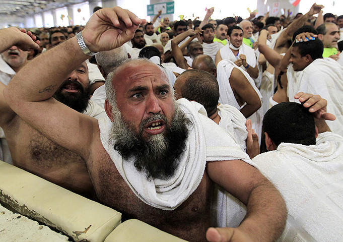 24 hours in pictures: Muslim pilgrims cast stones at a pillar, symbolizing the stoning of Satan