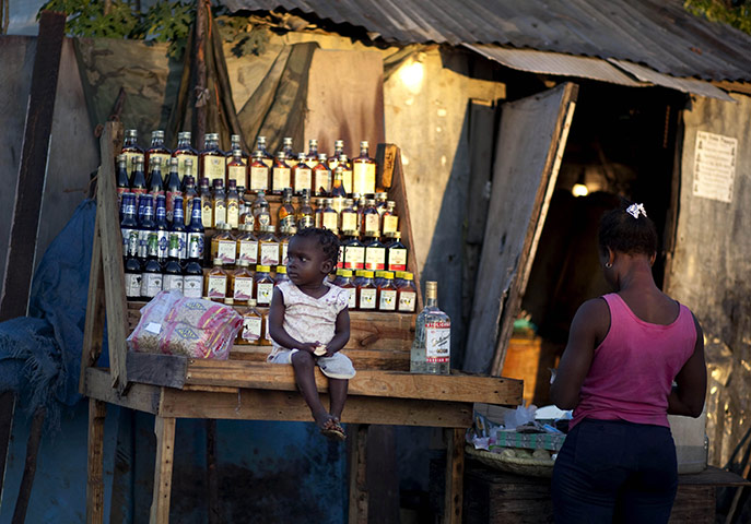 24 hours: Port-au-Prince, Haiti: A vendor waits for customers while her daughter sits
