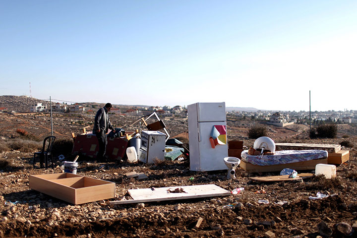 24 hours: Oz Zion, West Bank: A Jewish settler looks for his belongings in the rubble