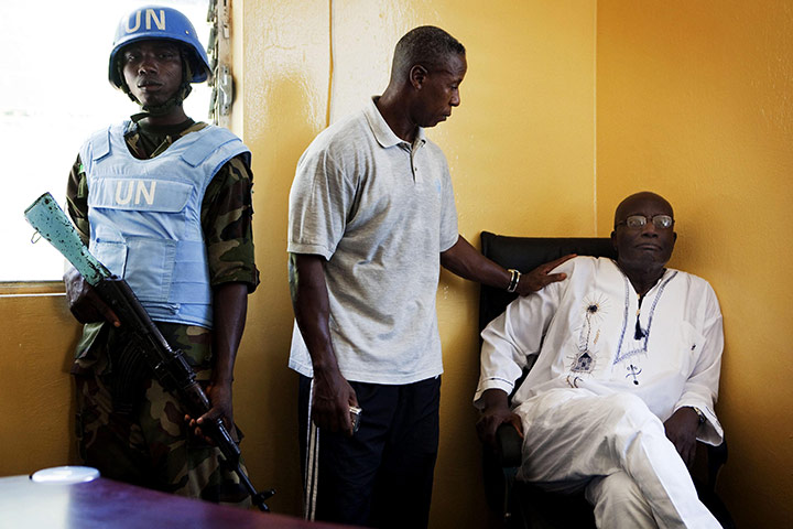 Liberia violence: Opposition leader Winston Tubman is comforted after an attack on his HQ