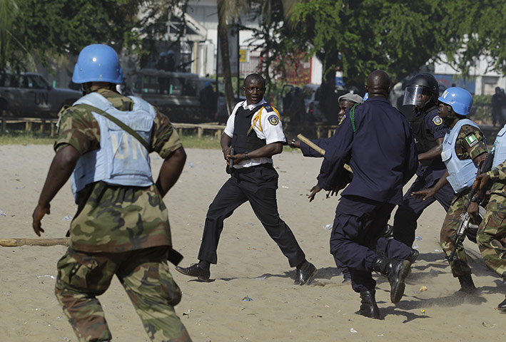 Liberia violence: UN soldiers and Liberian police chase down a Liberian police commander