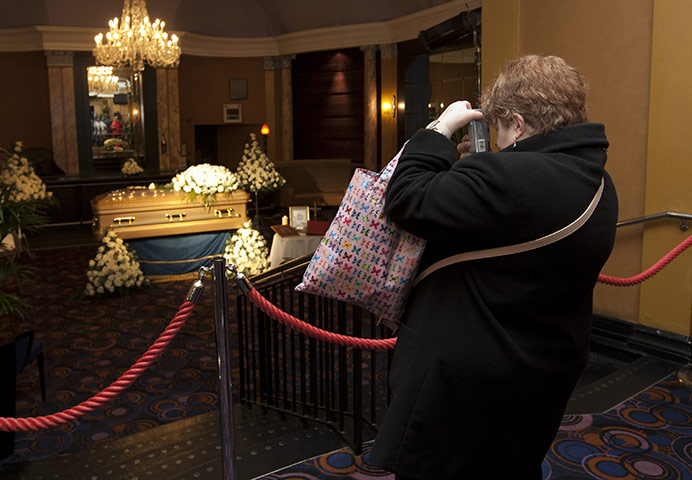 Jimmy Savile funeral: A member of the public takes a photograph