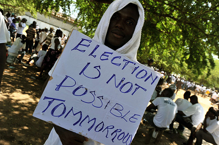 Liberia violence: A supporter of the opposition CDC party holds a placard at a rally