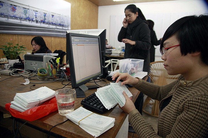 Ai Weiwei: A woman enters information into a computer