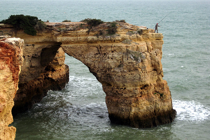 Your pictures: Portugese fisherman on cliff edge