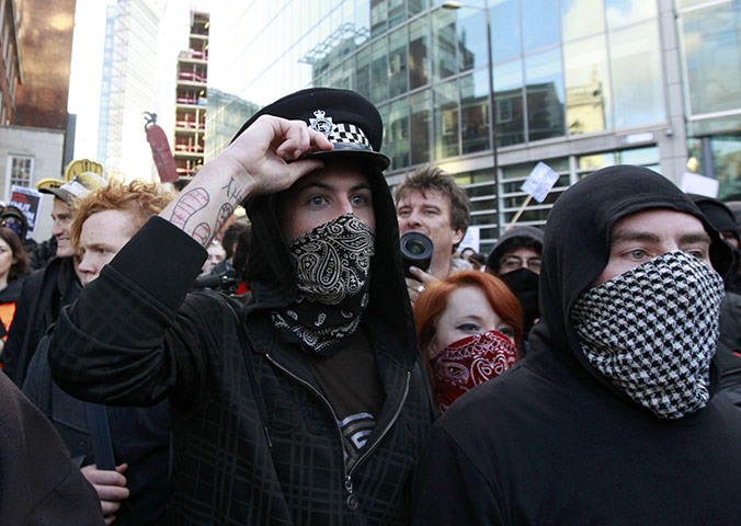Student protests update: A protester wears the hat from a police officer 