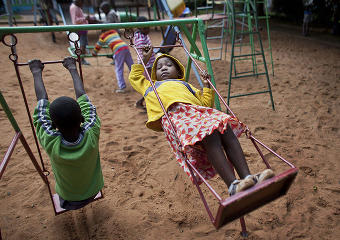 24 hours in pictures: Children play on the swings at Nyumbani Children's Home