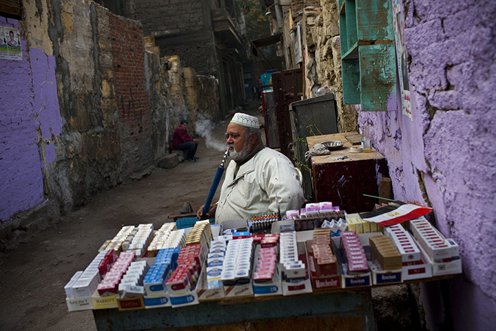24 hours in pictures: An Egyptian tobacco vendor waits for customers