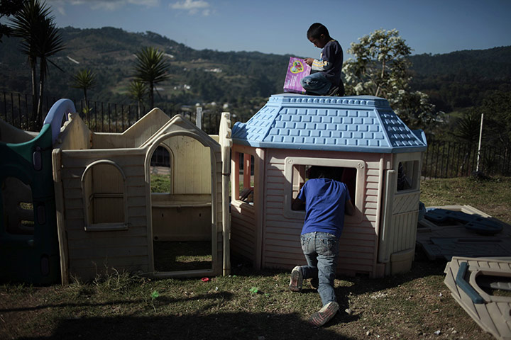24 hours in pictures: Children play in the yard at San Jose Hospice in Sacatepequez