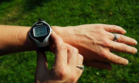 A woman checks her heart rate monitor