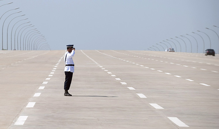 Hillary Clinton in Burma: police officer salutes