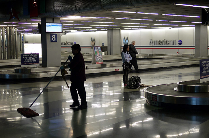 Week in business: American Airlines passengers wait for their luggage at O'Hare Airport 