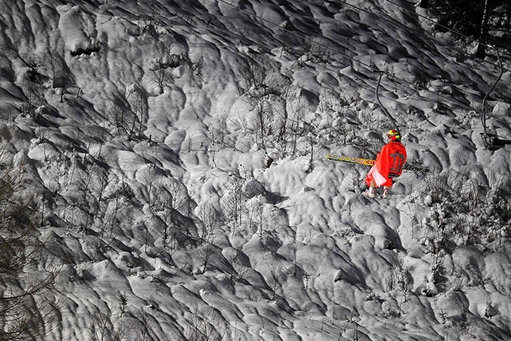 24 hours in pictures: Hilde of Norway sits on a chair lift at the ski jumping World Cup