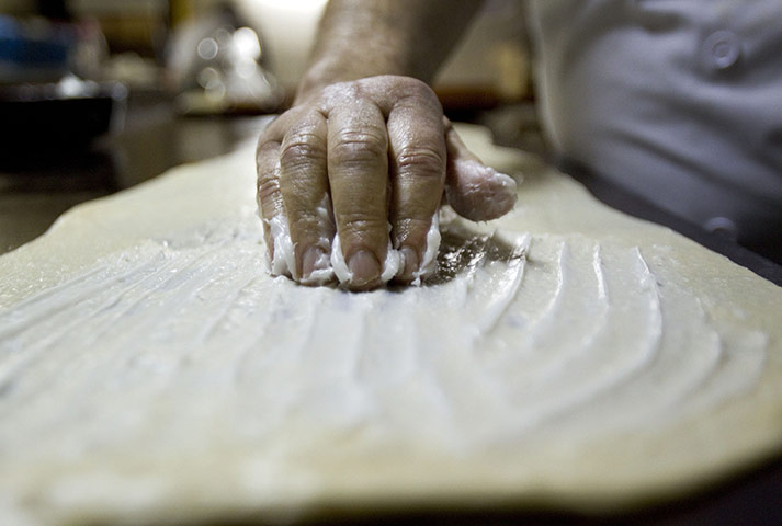 24 hours in pictures: Palma de Mallorca, Spain: Baker Miquel Antonio Pujol prepares ensaimadas