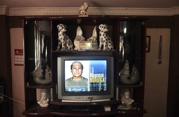 24 hours in pictures: An image of Panama's former strongman Manuel Noriega is shown on a TV set
