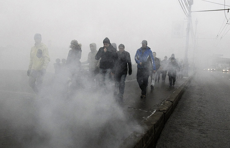 Moscow protests: People make their way to the demonstration through smoke from a flare