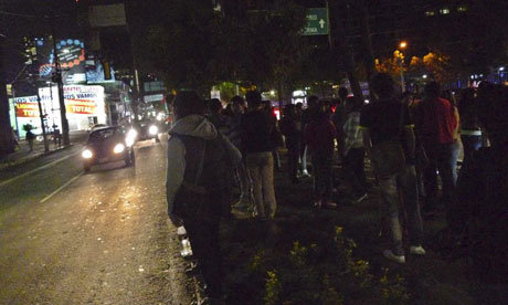 People stand on a nature strip in Mexico City after buildings were evacuated during an earthquake