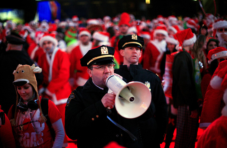 SantaCon 2011: A police officer speaks into a loud hailer in Times Square