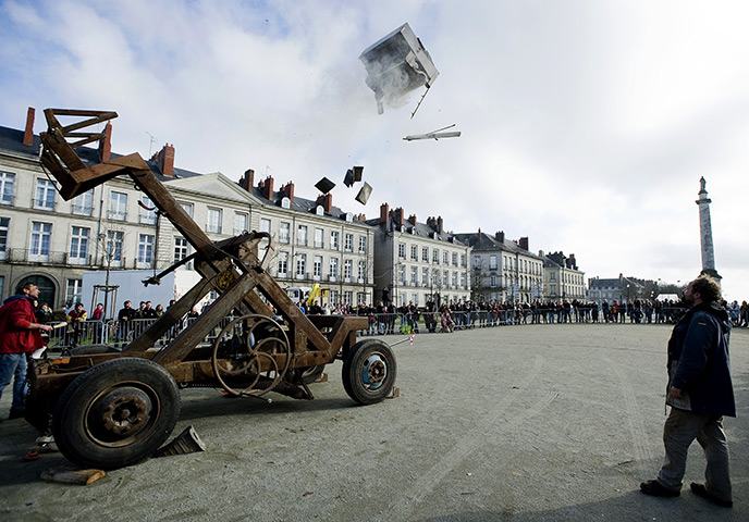 24 hours: Nantes, France: People watch as a piano is thrown with a catapult 