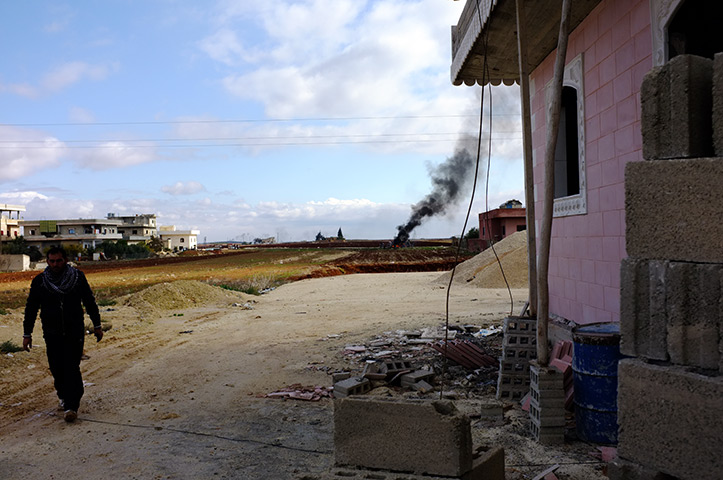 Syria: A plume of smoke rises in the town of Benish as the army approaches 