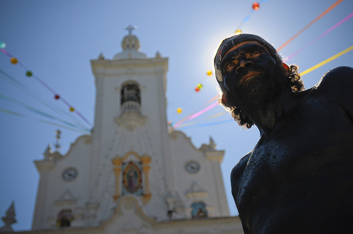 24 hours: San Salvador, El Salvador: A man stands during Virgin of Guadalupe day 