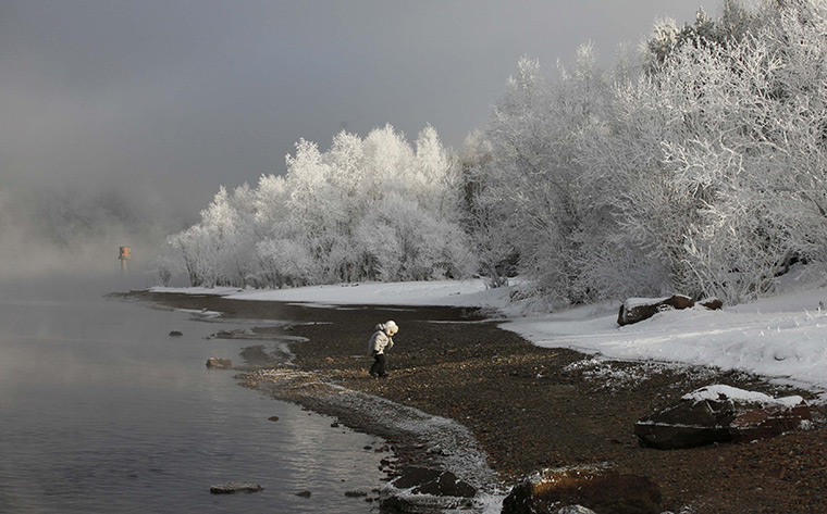 24 hours: Siberia, Russia: A child walks on the bank of the Yenisei River