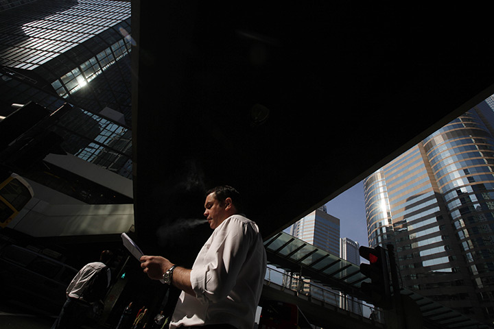 24 hours: Hong Kong, China: A man smokes in Central, business district