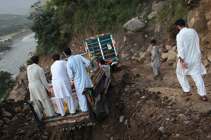 Declan Walsh: Swat Valley: Villagers cling to a jeep as they crawl along a dirt trail 