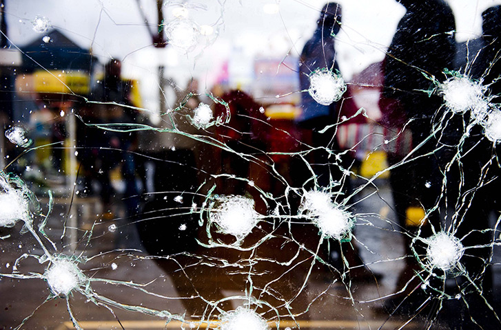 24 hours in pictures: Shattered glass in a window at Liege attack aftermath